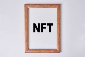 NFT art in the painting frame - a wooden frame with the word ntt in black