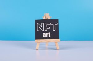 Painting art board with NFT Art text - a blackboard with the words nrt on it